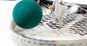 teal racquetball ball and protective eye wear laying on racquet basic equipment for racquetball rubber ball