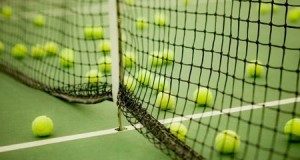 tennis balls scattered around the tennis court by the net regulated tennis ball